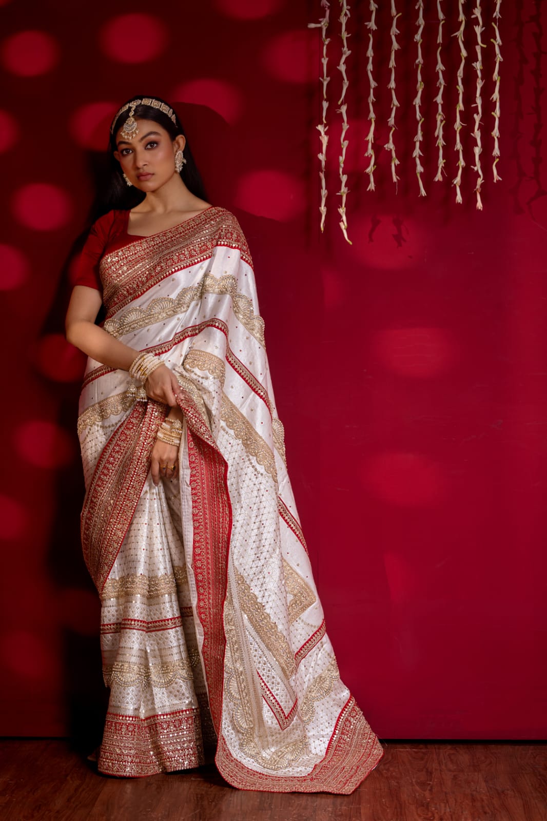 "Exquisite Handcrafted Saree in Red and White with Opulent Golden Zari Detailing – A True Luxury Statement"