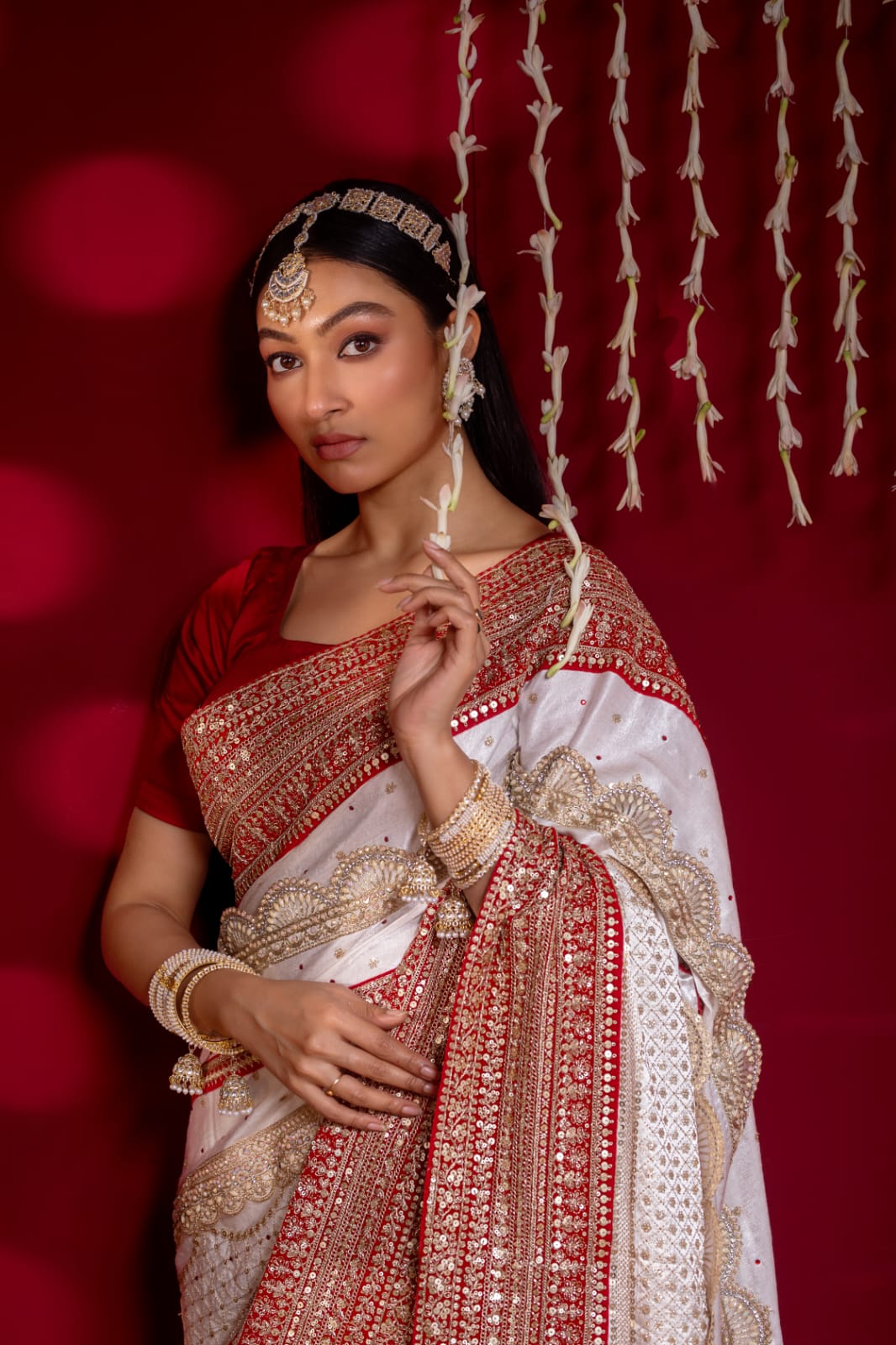 "Exquisite Handcrafted Saree in Red and White with Opulent Golden Zari Detailing – A True Luxury Statement"