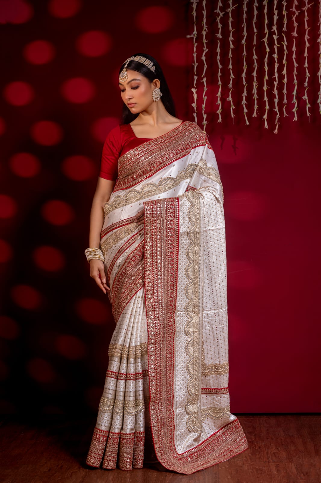 "Exquisite Handcrafted Saree in Red and White with Opulent Golden Zari Detailing – A True Luxury Statement"