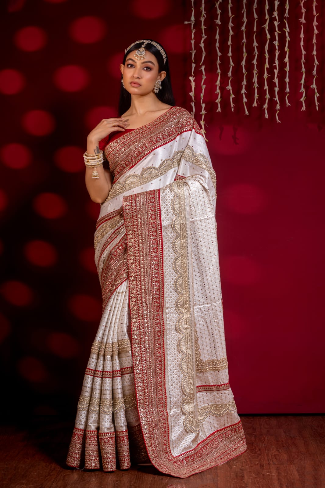 "Exquisite Handcrafted Saree in Red and White with Opulent Golden Zari Detailing – A True Luxury Statement"